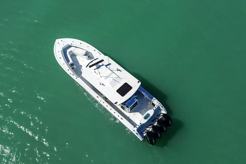 Slide: The Image of 2024 Yellowfin 42 Offshore boat on turquoise water, aerial view. - 11