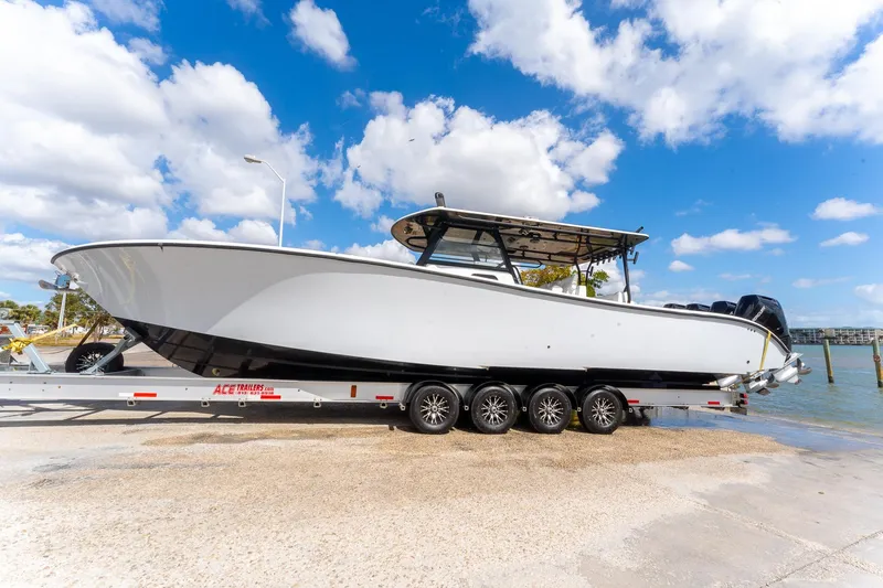Slide: The Image of 2024 Yellowfin 42 Offshore boat on trailer under blue sky. - 13