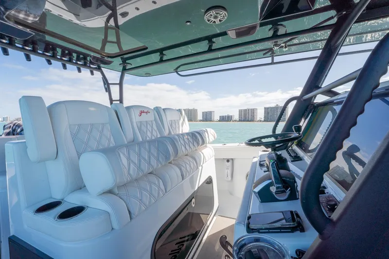 Slide: The Image of 2024 Yellowfin 42 Offshore boat interior with luxurious seating and advanced navigation controls. - 20