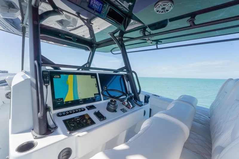 Slide: The Image of 2024 Yellowfin 42 Offshore boat cockpit with advanced navigation system and ocean view. - 21