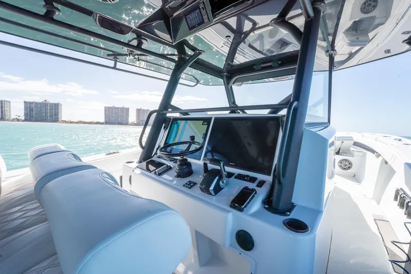 Slide: The Image of 2024 Yellowfin 42 Offshore boat cockpit with modern navigation system and ocean view. - 22