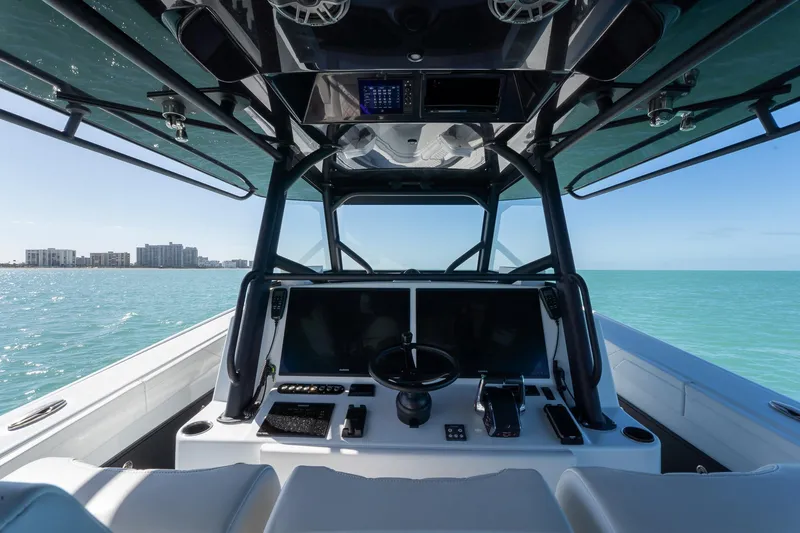 Slide: The Image of 2024 Yellowfin 42 Offshore boat interior with modern dashboard on open sea. - 24