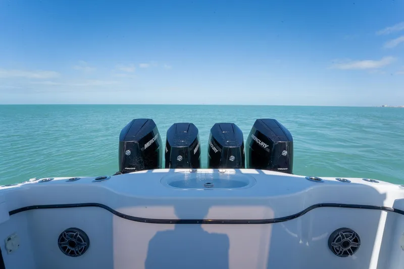 Slide: The Image of 2024 Yellowfin 42 Offshore boat with four Mercury engines on open sea. - 30