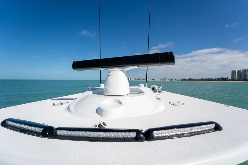 Slide: The Image of 2024 Yellowfin 42 Offshore boat on calm sea with clear blue sky. - 34