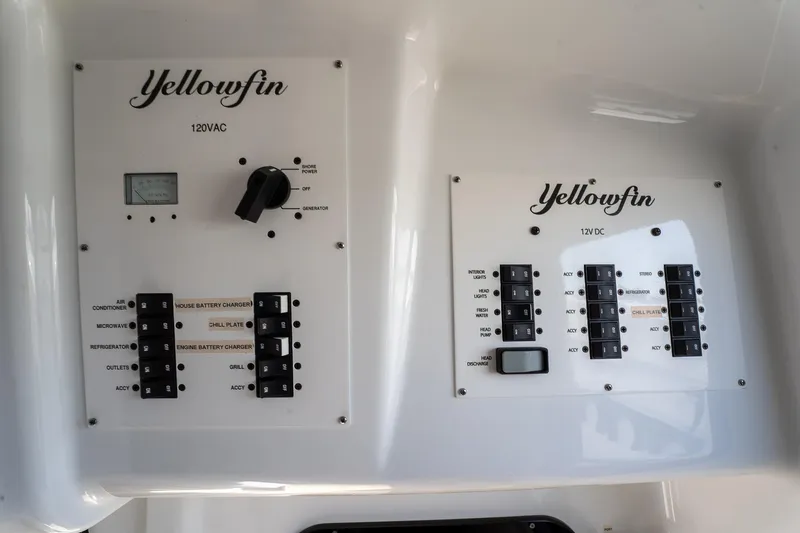 Slide: The Image of Electrical control panels on 2024 Yellowfin 42 Offshore boat, featuring 120VAC and 12VDC systems. - 37