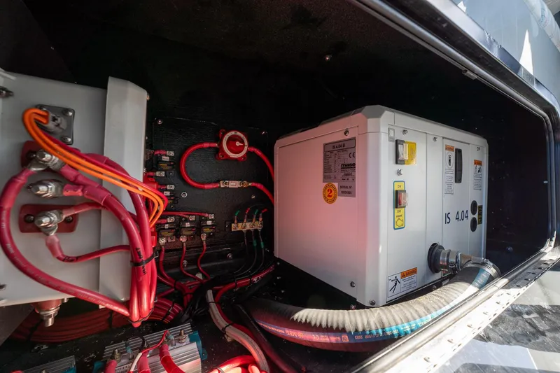 Slide: The Image of Electrical system inside 2024 Yellowfin 42 Offshore boat, featuring wiring and control units. - 38