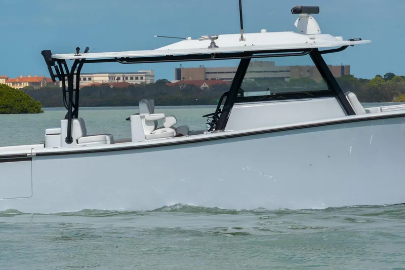 Slide: The Image of 2024 Yellowfin 42 Offshore boat cruising on calm waters, showcasing sleek design and modern features. - 4