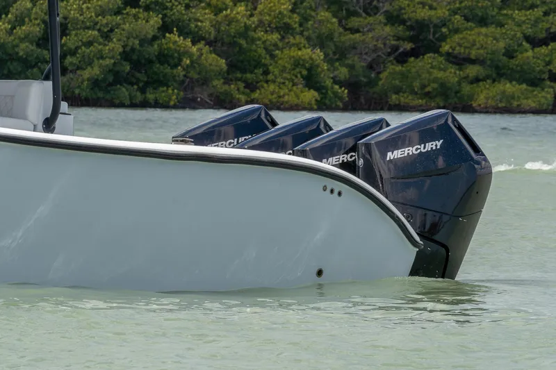 Slide: The Image of 2024 Yellowfin 42 Offshore boat with Mercury outboard engines in calm water. - 6