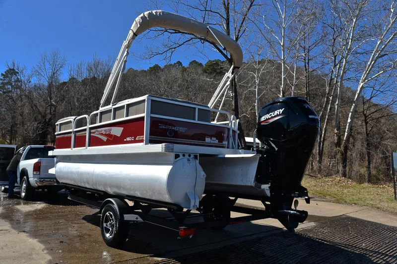 Slide: The Image of 2021 Ranger 180 Reata pontoon boat with Mercury engine on trailer, outdoors. - 12