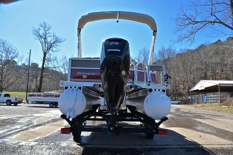 Slide: The Image of 2021 Ranger 180 Reata boat on trailer, rear view, outdoors in a parking area. - 13