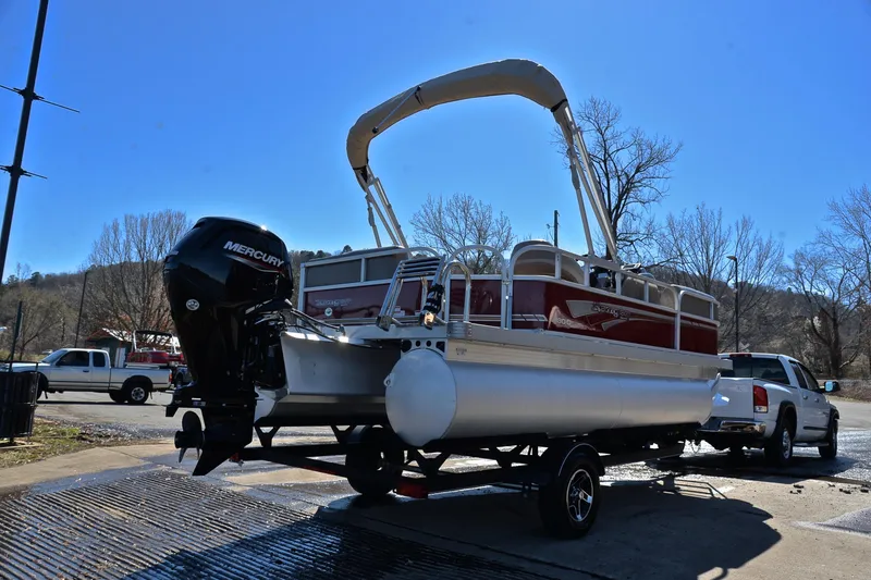 Slide: The Image of 2021 Ranger 180 Reata boat on trailer with Mercury engine, parked outdoors. - 14