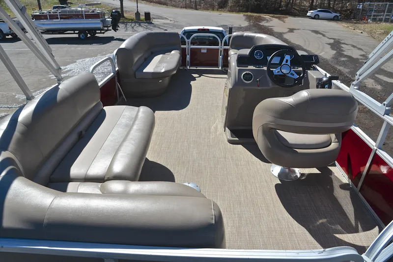 Slide: The Image of 2021 Ranger 180 Reata boat interior with beige seating and steering console. - 18
