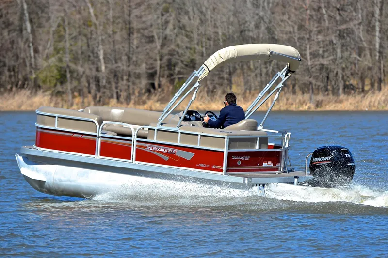 Slide: The Image of 2021 Ranger 180 Reata boat cruising on a lake with a Mercury outboard motor. - 4