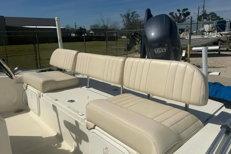 Slide: The Image of 2010 Hydra-Sports Bay Bolt 19 boat interior with beige seating and Yamaha 150 engine. - 11