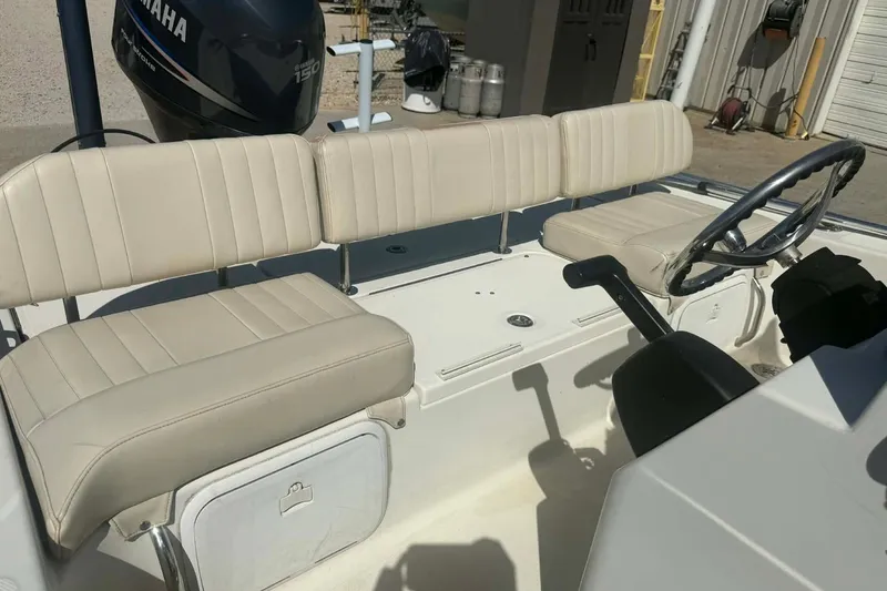 Slide: The Image of 2010 Hydra-Sports Bay Bolt 19 boat interior with beige seating and Yamaha engine. - 8