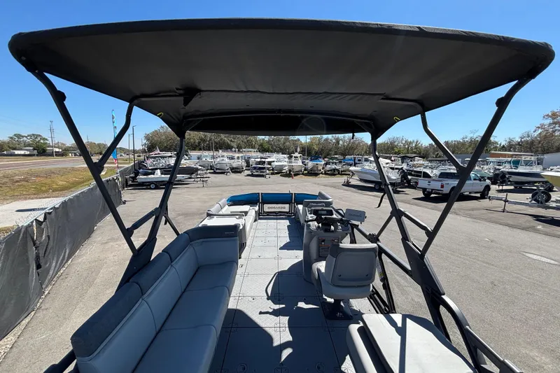 Slide: The Image of 2023 Sea-Doo Switch Cruise 21 pontoon boat interior with seating and helm. - 13
