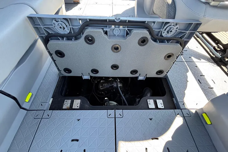 Slide: The Image of 2023 Sea-Doo Switch Cruise 21 interior with seating and controls, parked outdoors. - 15