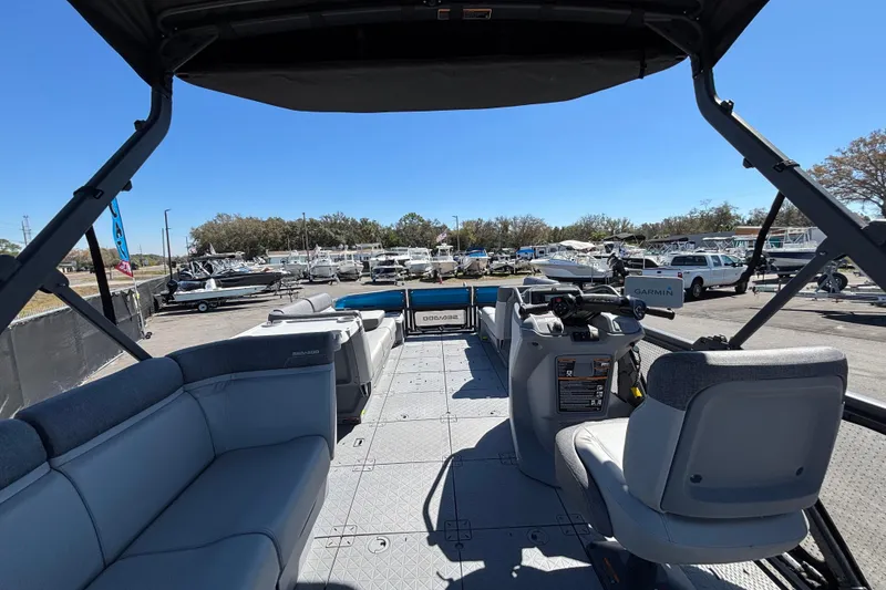 Slide: The Image of 2023 Sea-Doo Switch Cruise 21 pontoon boat interior with seating and control console. - 27