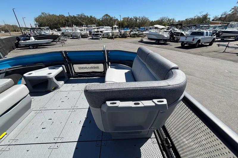 Slide: The Image of 2023 Sea-Doo Switch Cruise 21 interior with gray seating, docked among other boats. - 43