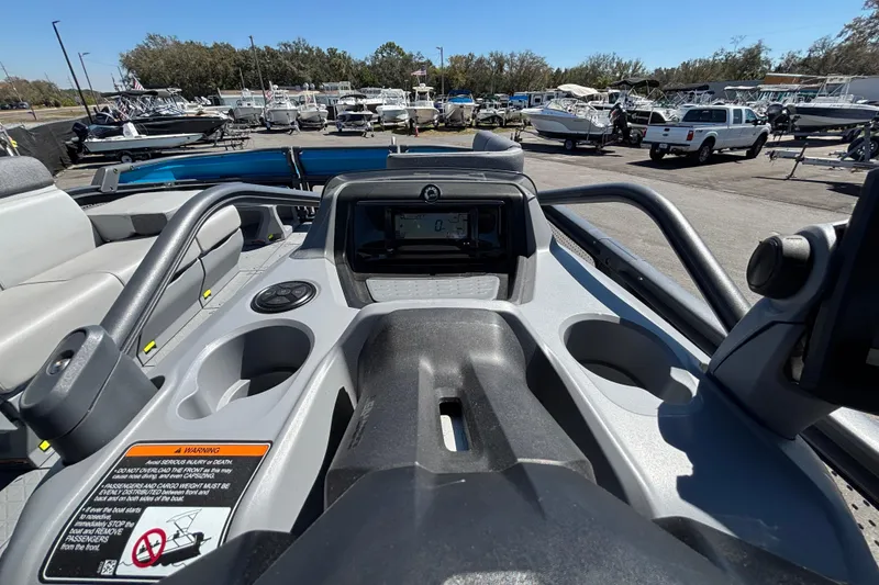 Slide: The Image of 2023 Sea-Doo Switch Cruise 21 dashboard view at a marina with boats. - 67