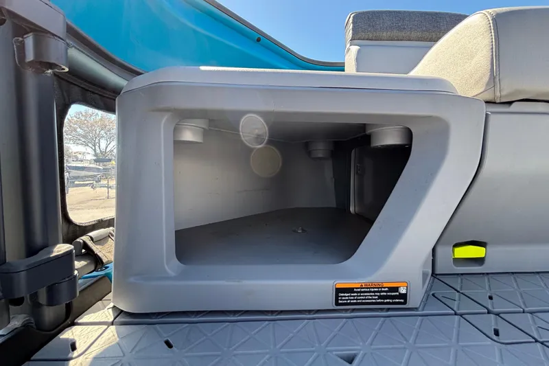 Slide: The Image of 2023 Sea-Doo Switch Cruise 21 storage compartment with seating and blue accents. - 77