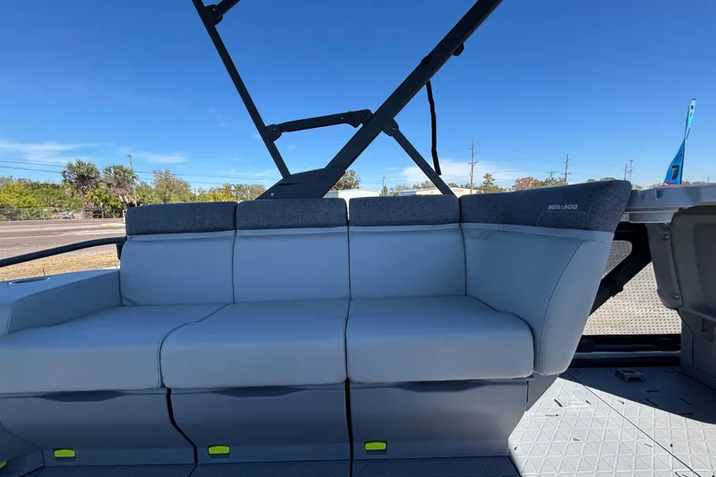 Slide: The Image of 2023 Sea-Doo Switch Cruise 21 interior seating with gray upholstery and outdoor backdrop. - 82