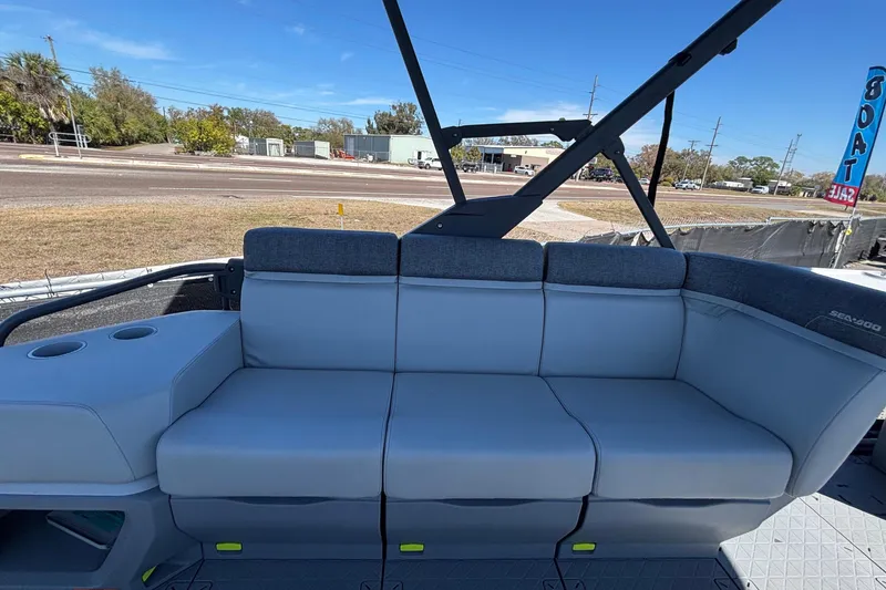 Slide: The Image of 2023 Sea-Doo Switch Cruise 21 boat with comfortable seating and cup holders, parked outdoors. - 83