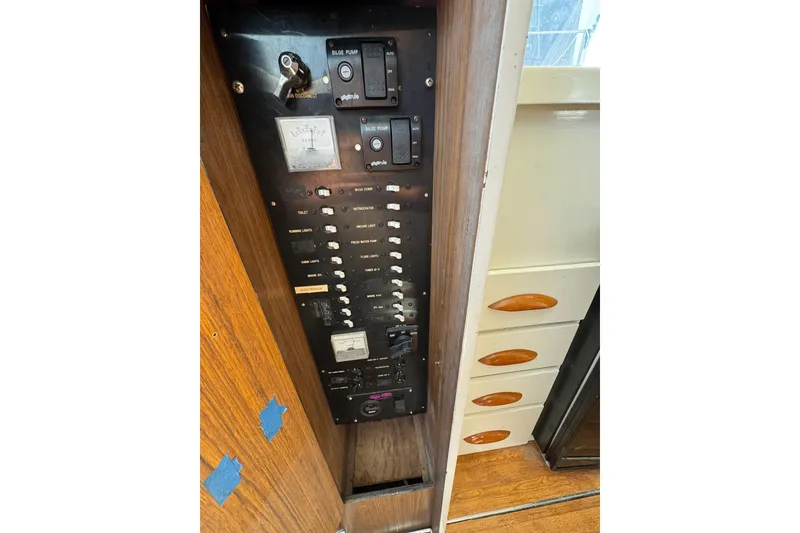 Slide: The Image of Electrical panel of a 1963 Bertram 31 Sportfisher boat with switches and gauges. - 11