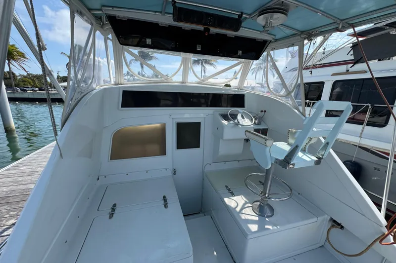 Slide: The Image of 1963 Bertram 31 Sportfisher helm with blue captain's chair and steering wheel. - 12