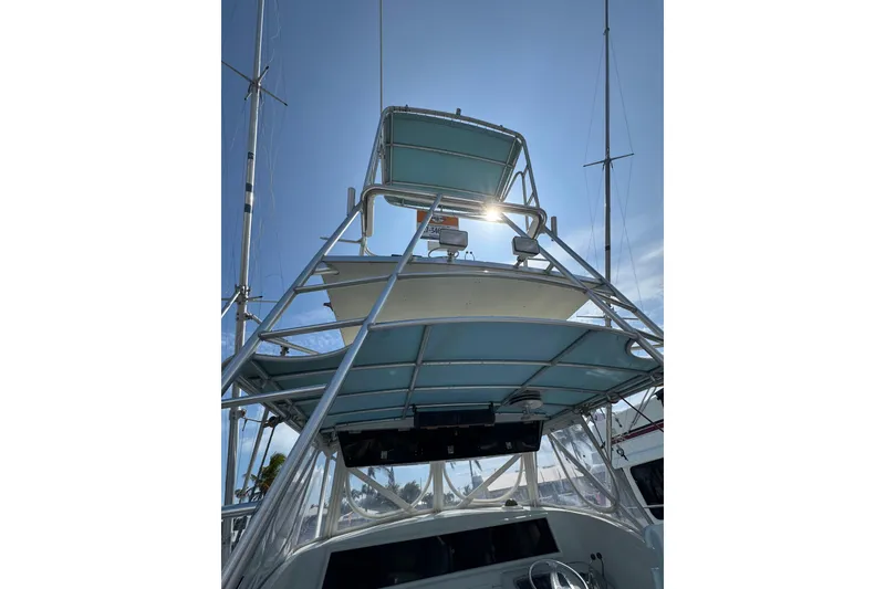 Slide: The Image of 1963 Bertram 31 Sportfisher boat tower against a clear blue sky. - 14