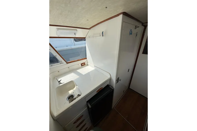Slide: The Image of Interior of 1963 Bertram 31 Sportfisher with sink and storage. - 5