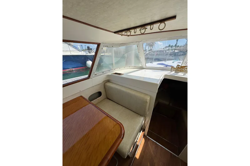 Slide: The Image of Interior of a 1963 Bertram 31 Sportfisher boat with seating and wooden table. - 8