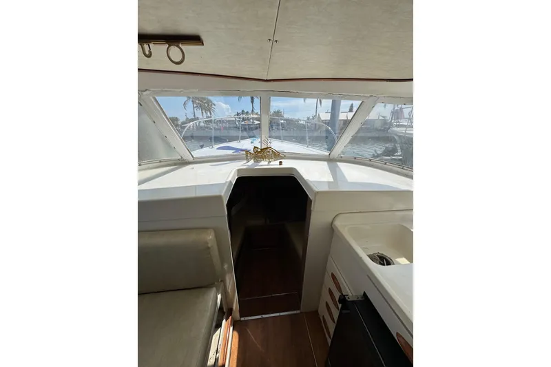 Slide: The Image of Interior view of a 1963 Bertram 31 Sportfisher boat, showcasing helm and seating area. - 9