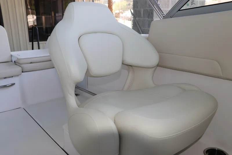 Slide: The Image of 2026 Robalo R207 Dual Console boat with luxurious white seating. - 16