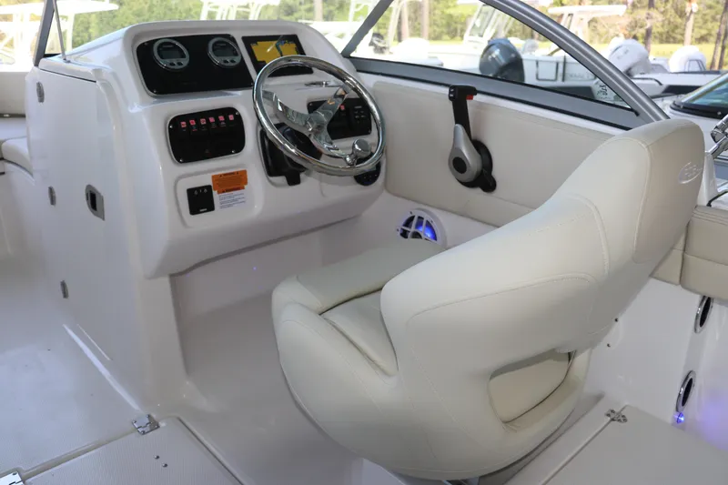 Slide: The Image of 2026 Robalo R207 Dual Console boat interior with steering wheel and control panel. - 17