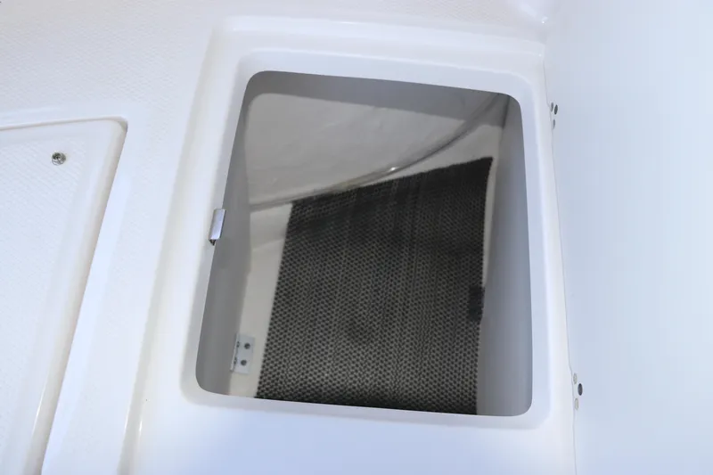 Slide: The Image of Storage compartment of 2026 Robalo R207 Dual Console boat, featuring a sleek interior design. - 28