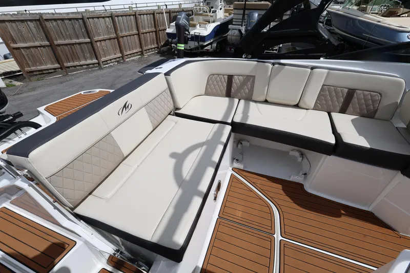Slide: The Image of Luxurious seating on a 2021 Monterey M-65 boat with elegant upholstery and teak flooring. - 11