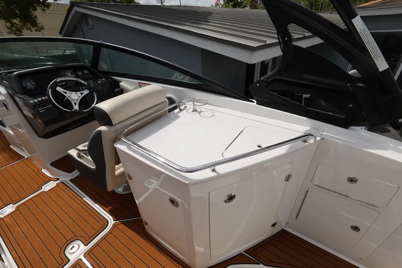 Slide: The Image of 2021 Monterey M-65 boat interior with sleek dashboard and wooden flooring. - 12