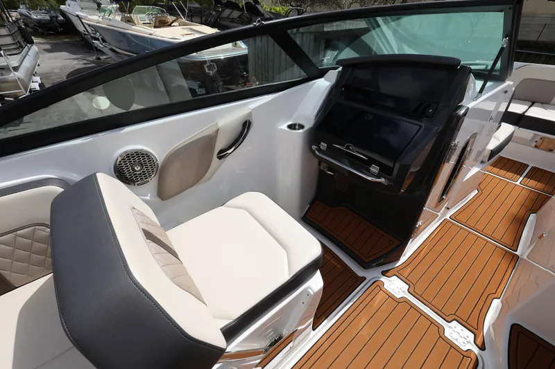 Slide: The Image of 2021 Monterey M-65 boat interior with modern seating and wood-style flooring. - 13