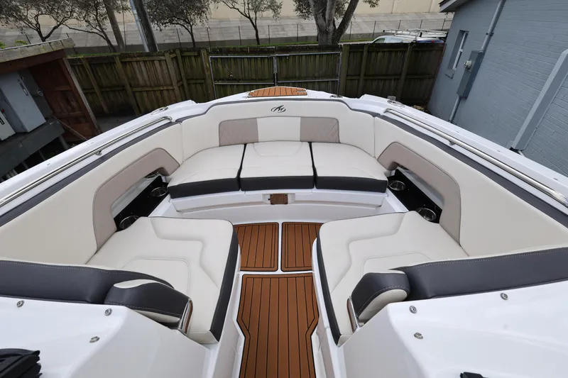 Slide: The Image of 2021 Monterey M-65 boat interior with luxurious seating and teak flooring. - 14