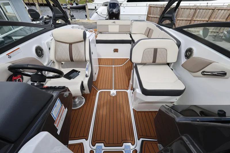 Slide: The Image of 2021 Monterey M-65 boat interior with luxurious seating and wood-style flooring. - 18