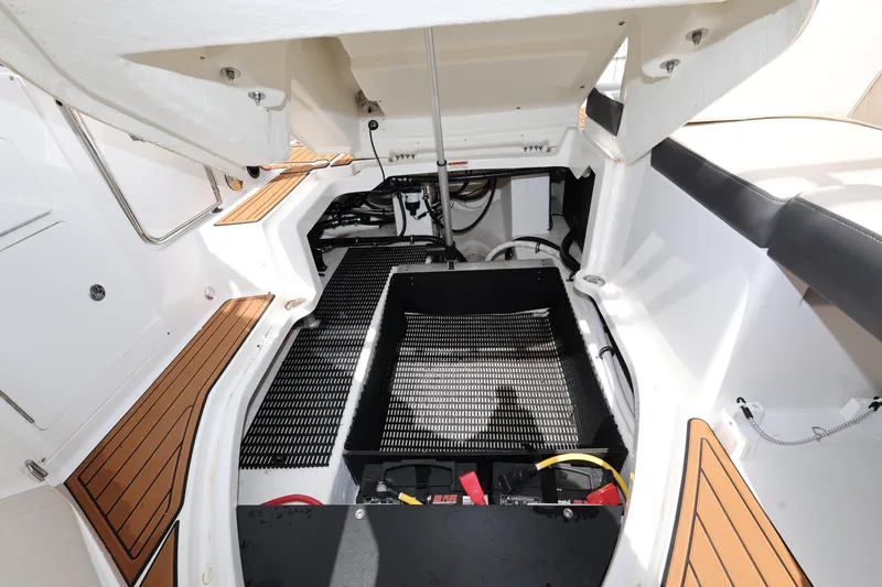 Slide: The Image of Engine compartment of 2021 Monterey M-65 boat with open hatch and visible components. - 23