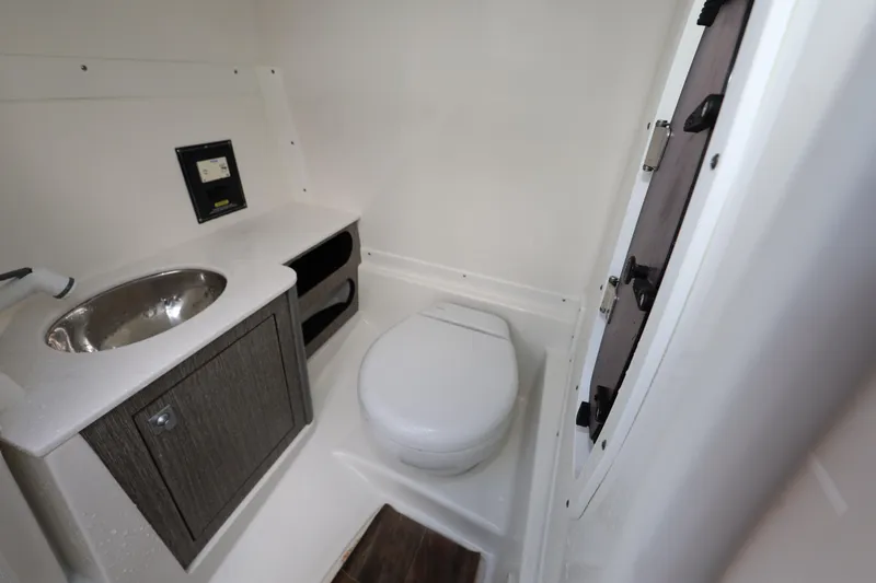Slide: The Image of Compact bathroom in 2021 Monterey M-65 boat with sink, toilet, and storage. - 25