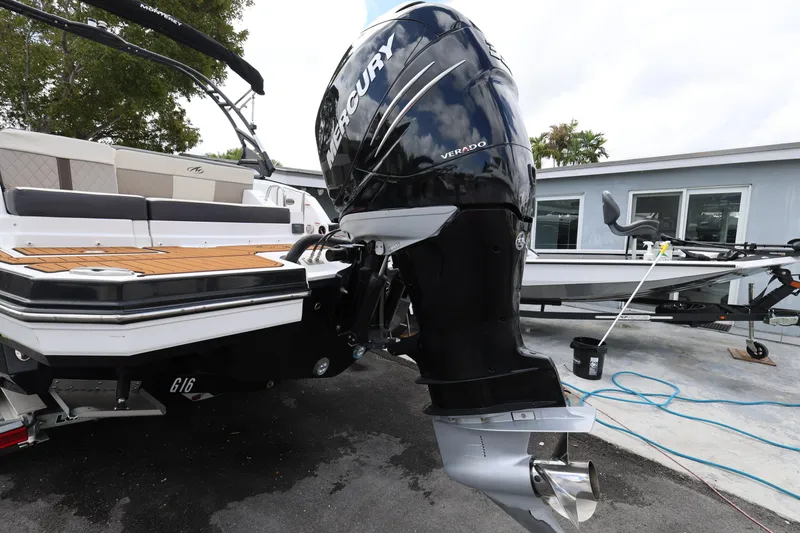 Slide: The Image of 2021 Monterey M-65 boat with Mercury Verado outboard engine, docked near a modern building. - 6