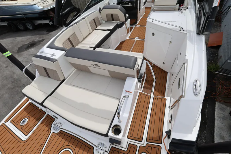 Slide: The Image of 2021 Monterey M-65 boat interior with luxurious seating and teak-style flooring. - 9