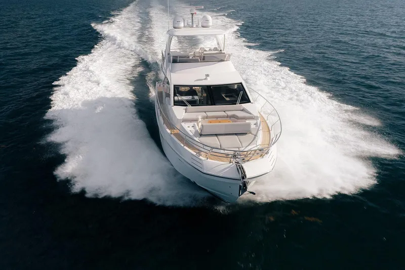 Slide: The Image of Luxurious 2020 Azimut 60 yacht cruising on open water, creating a dynamic wake. - 38
