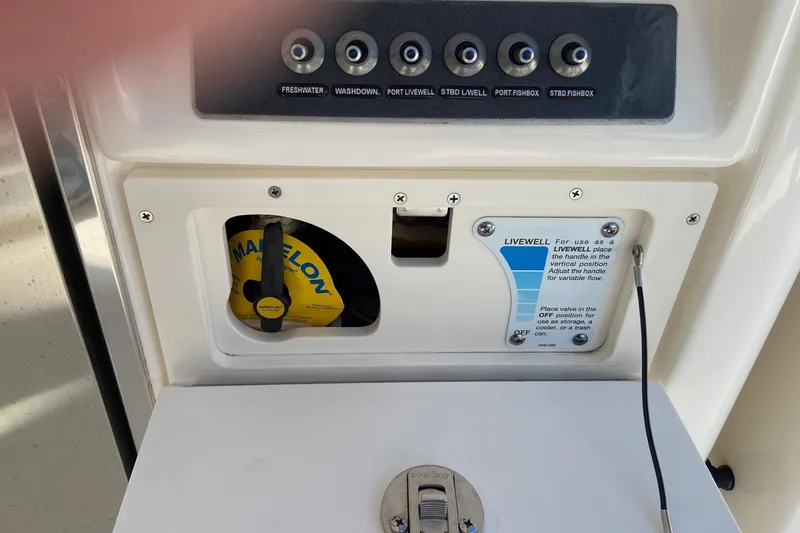 Slide: The Image of Control panel and livewell valve on a 2024 Boston Whaler 320 Vantage boat. - 10