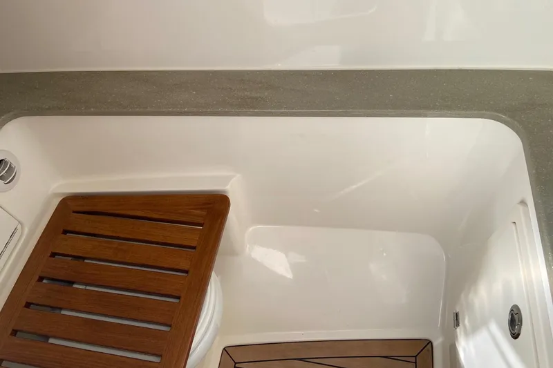 Slide: The Image of 2024 Boston Whaler 320 Vantage interior with wooden accents and sleek design. - 16