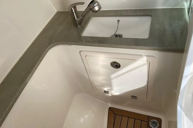 Slide: The Image of 2024 Boston Whaler 320 Vantage interior sink and countertop detail. - 17