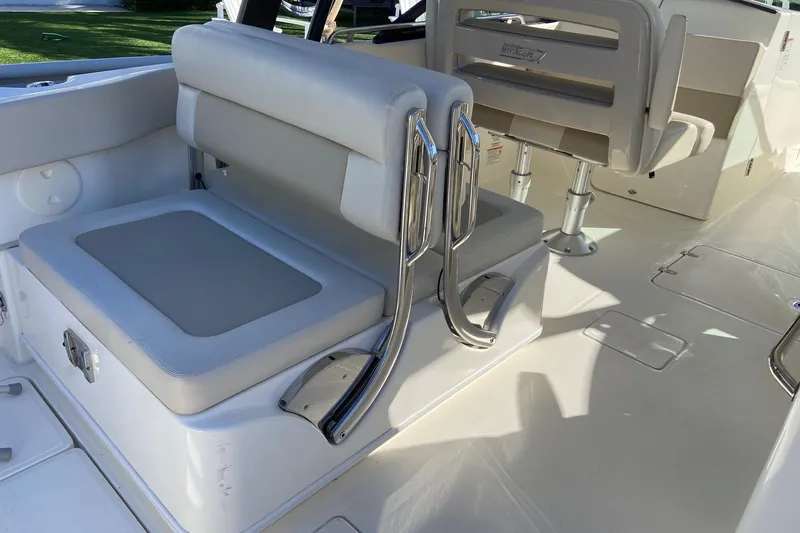 Slide: The Image of 2024 Boston Whaler 320 Vantage interior seating with sleek design and chrome accents. - 19